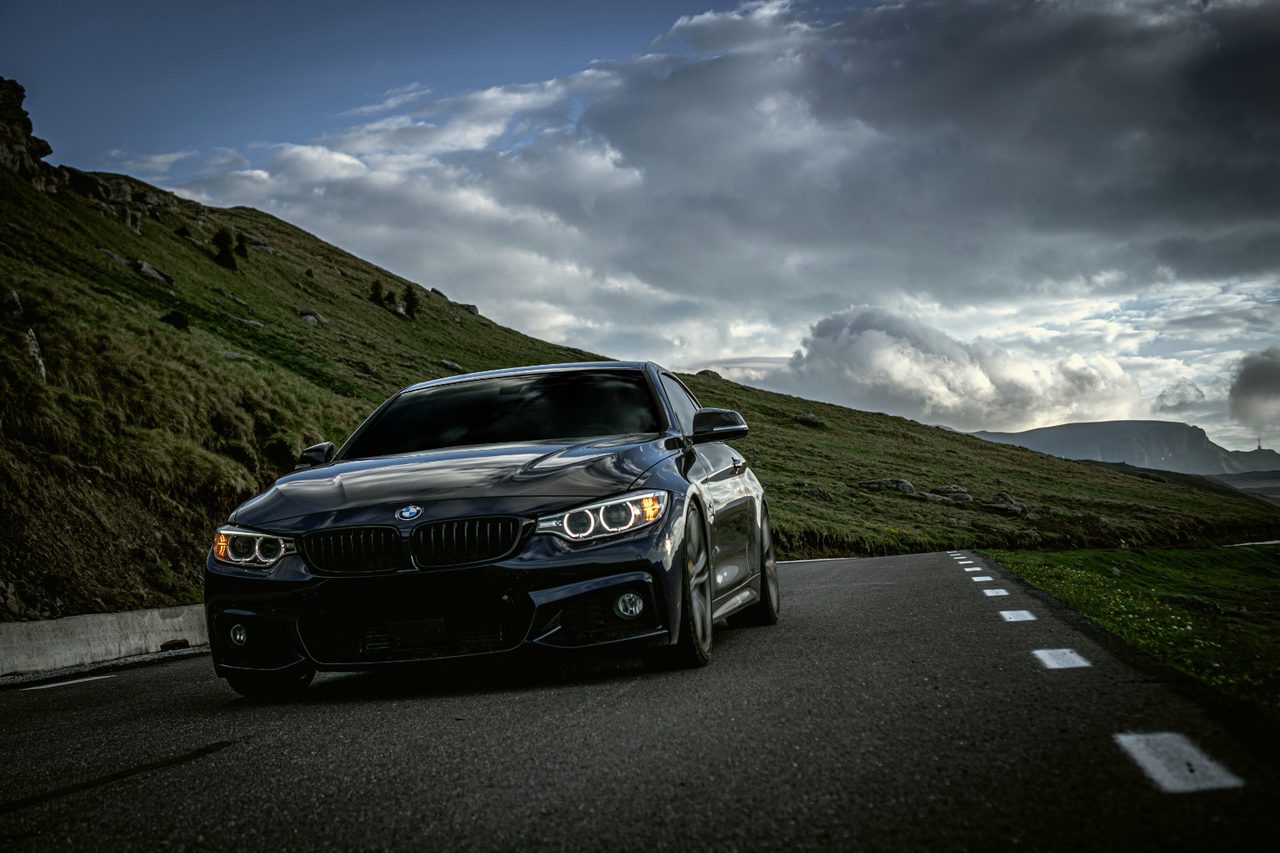 Black BMW saloon on an open road, representative of intercity coverage