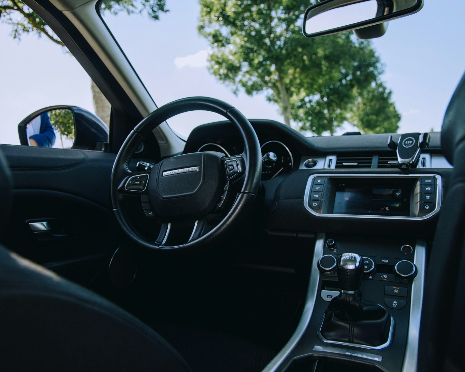 Range Rover interior with steering wheel and view to trees